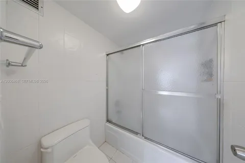 a bathroom with a shower and toilet