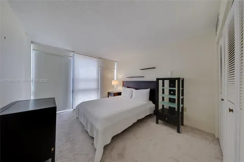 a bedroom with a bed and a night stand