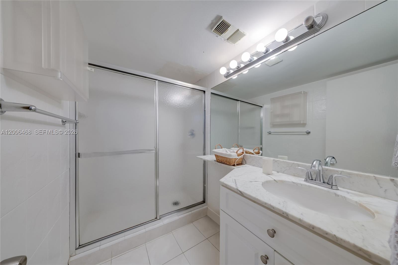 600 Northeast 36th Street, Unit 421 Miami, FL 33137 - Photo 14 of 16 a bathroom with a double vanity sink and a mirror