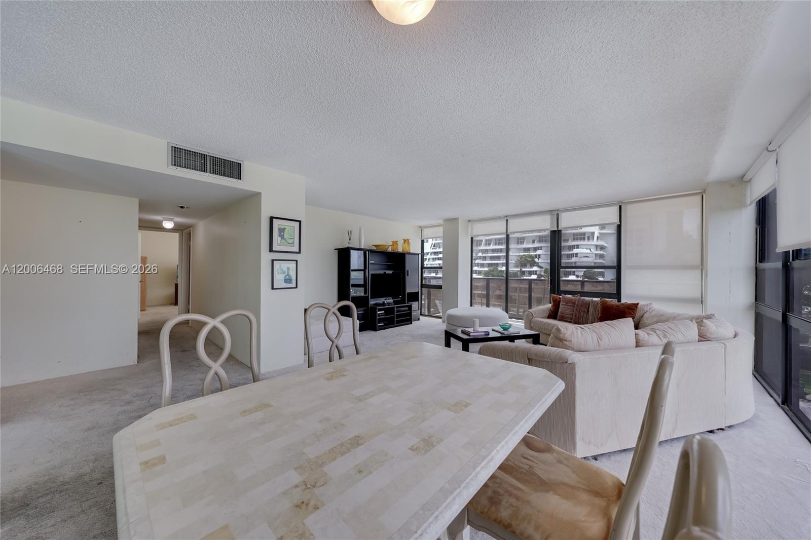 600 Northeast 36th Street, Unit 421 Miami, FL 33137 - Photo 3 of 16 a bedroom with furniture and a flat screen tv