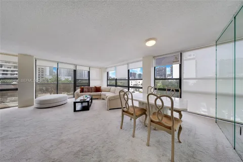 a living room with furniture and a floor to ceiling window