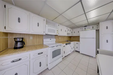 a kitchen with cabinets and window