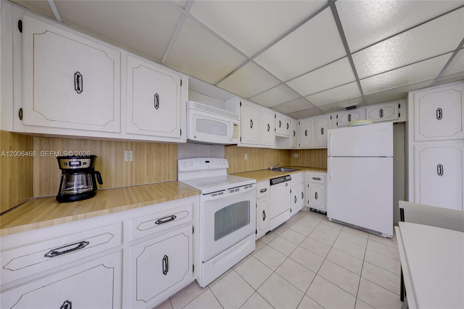 600 Northeast 36th Street, Unit 421 Miami, FL 33137 - Photo 6 of 16 a kitchen with cabinets and window