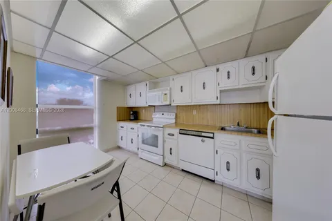 a kitchen with cabinets a sink and appliances