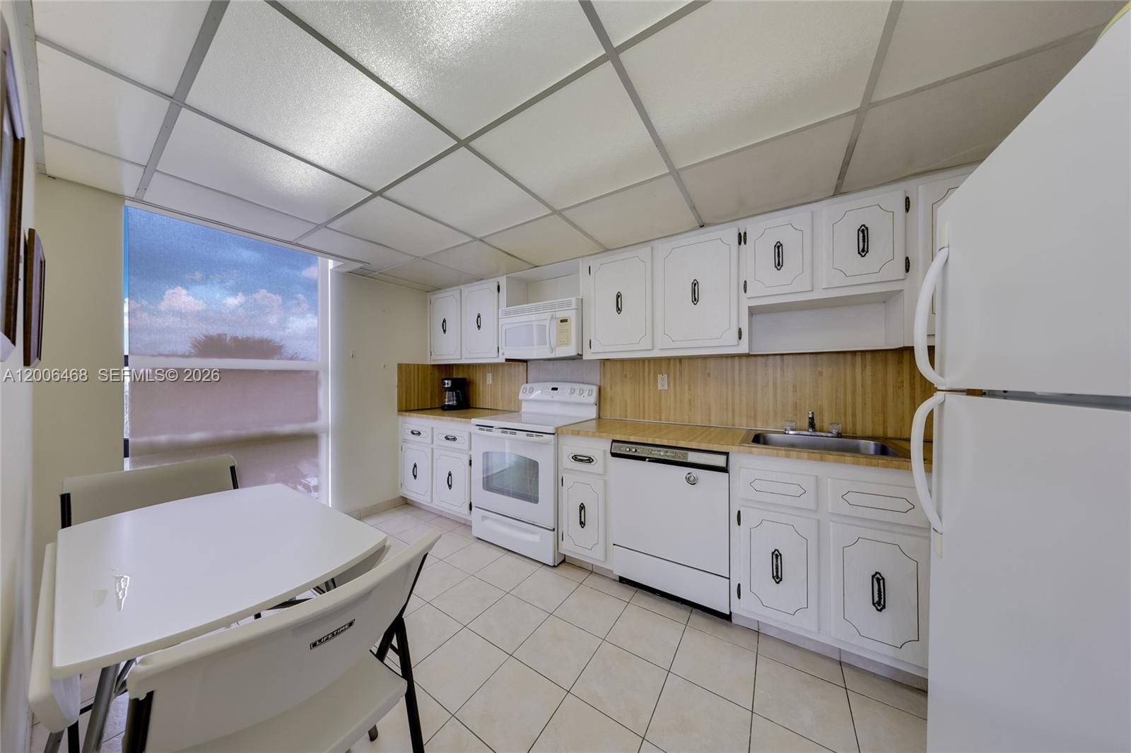 600 Northeast 36th Street, Unit 421 Miami, FL 33137 - Photo 7 of 16 a kitchen with cabinets a sink and appliances