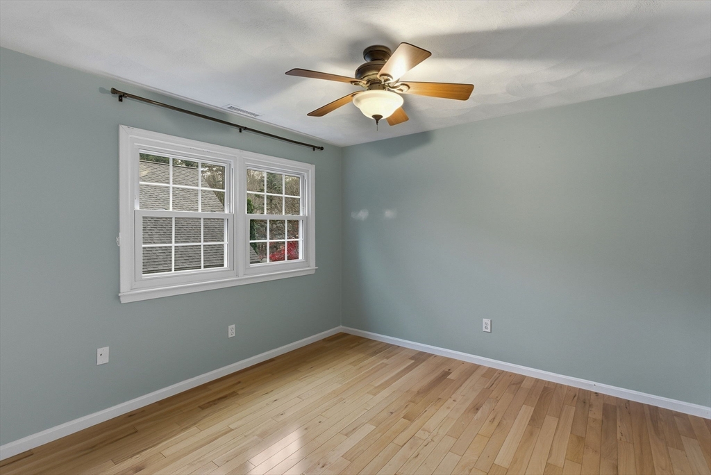 5 Aspen Circle Bedford, MA 01730 - Photo 22 of 28 a view of an empty room with wooden floor and a window