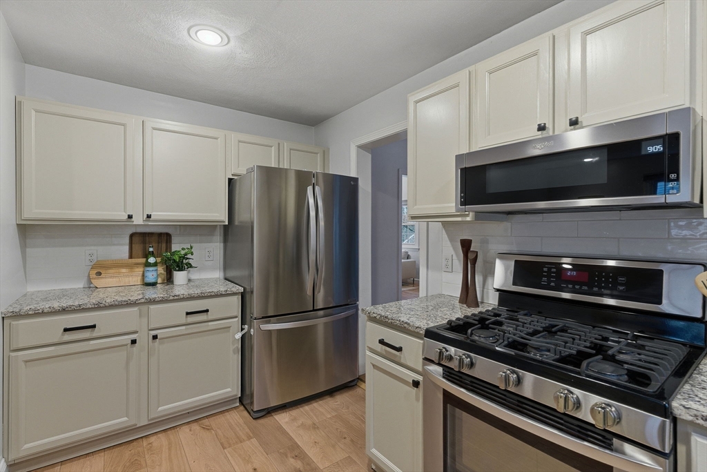 5 Aspen Circle Bedford, MA 01730 - Photo 7 of 28 a kitchen with cabinets stainless steel appliances and a counter space