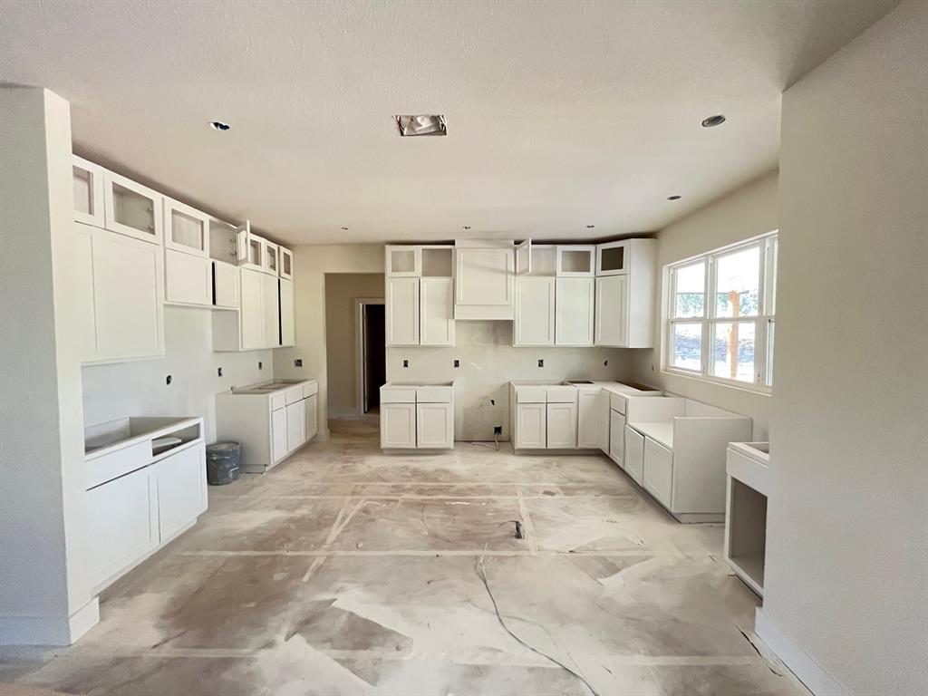 317 Jonny Boy Way Springtown, TX 76082 - Photo 5 of 7 a large white kitchen with a stove a sink dishwasher and a refrigerator