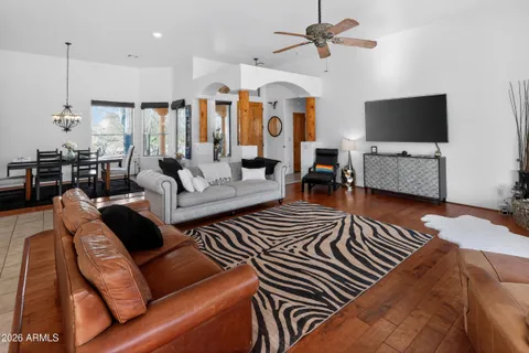 a living room with furniture kitchen view and a fireplace