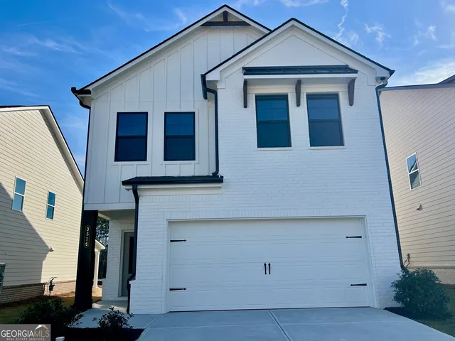 a front view of a house with garage