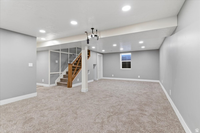 170 North 200 West Springville, UT 84663 - Photo 9 of 13 Spacious finished basement featuring light gray walls, plush carpet flooring, a natural wood staircase with white risers, ample recessed lighting, and a single basement window