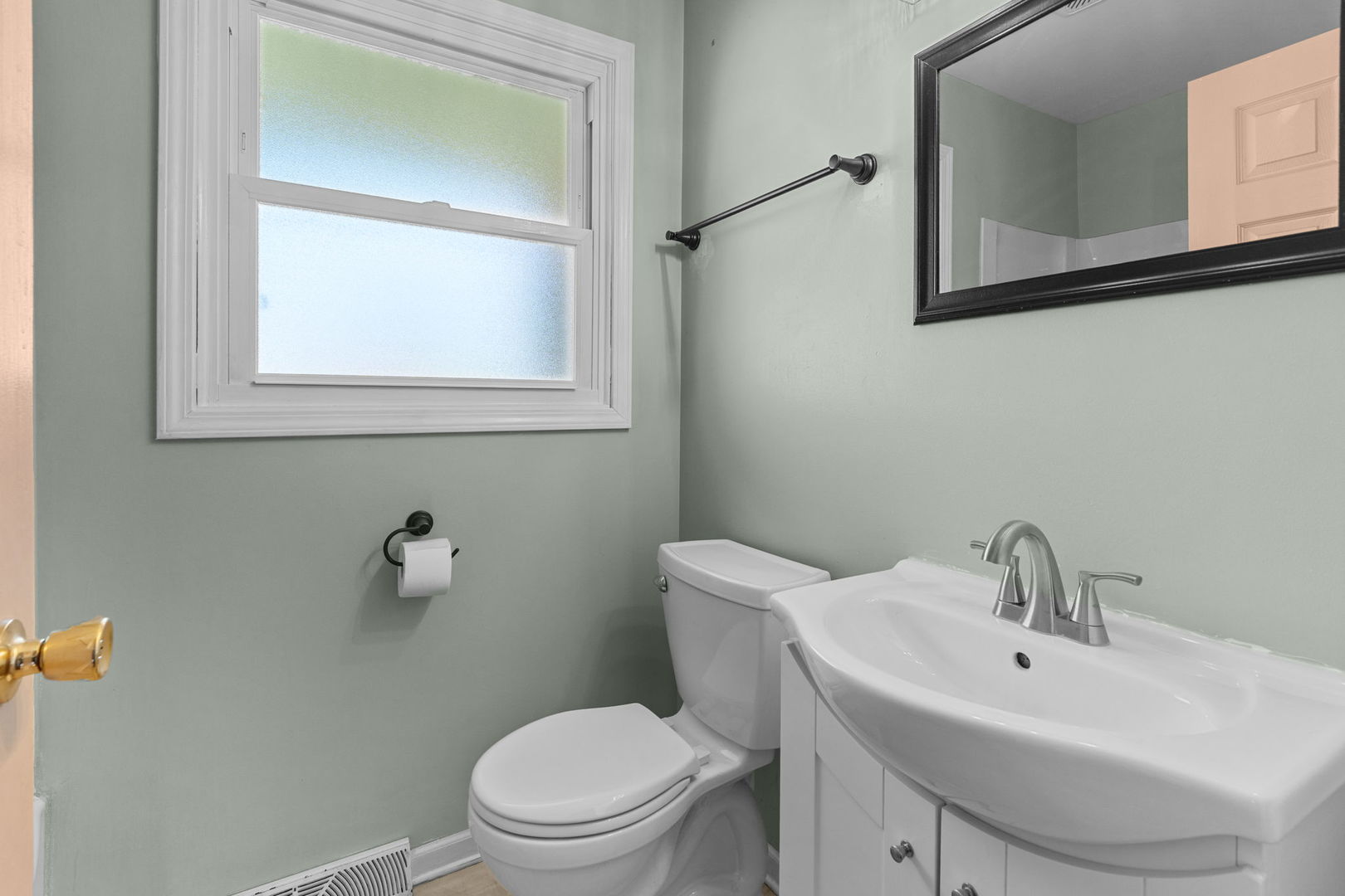 8911 Ramble Road Wonder Lake, IL 60097 - Photo 12 of 36 a white toilet sitting next to a bathroom sink