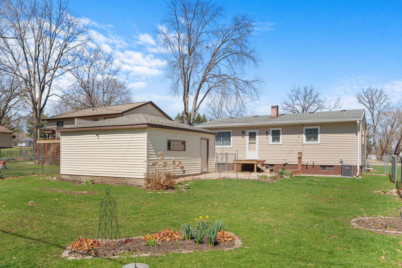 8911 Ramble Road Wonder Lake, IL 60097 - Photo 23 of 36 a front view of a house with a yard and garage