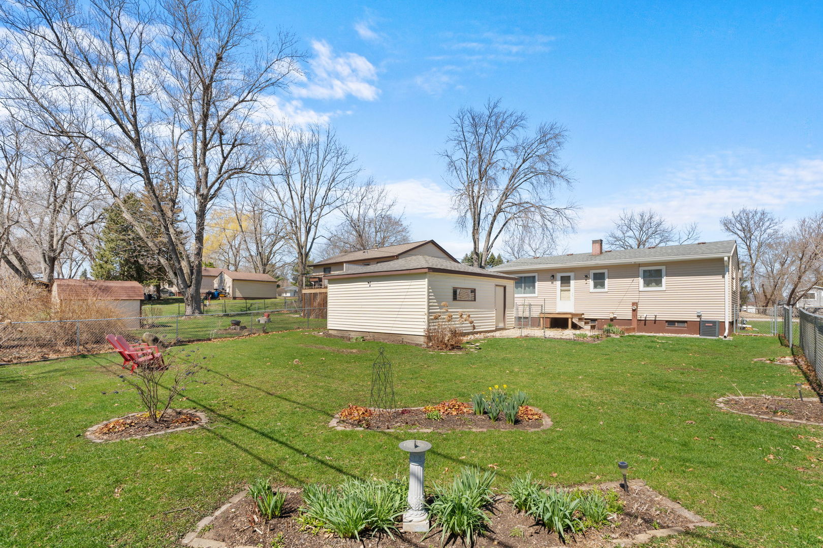8911 Ramble Road Wonder Lake, IL 60097 - Photo 24 of 36 a view of a white house with a big yard and large trees