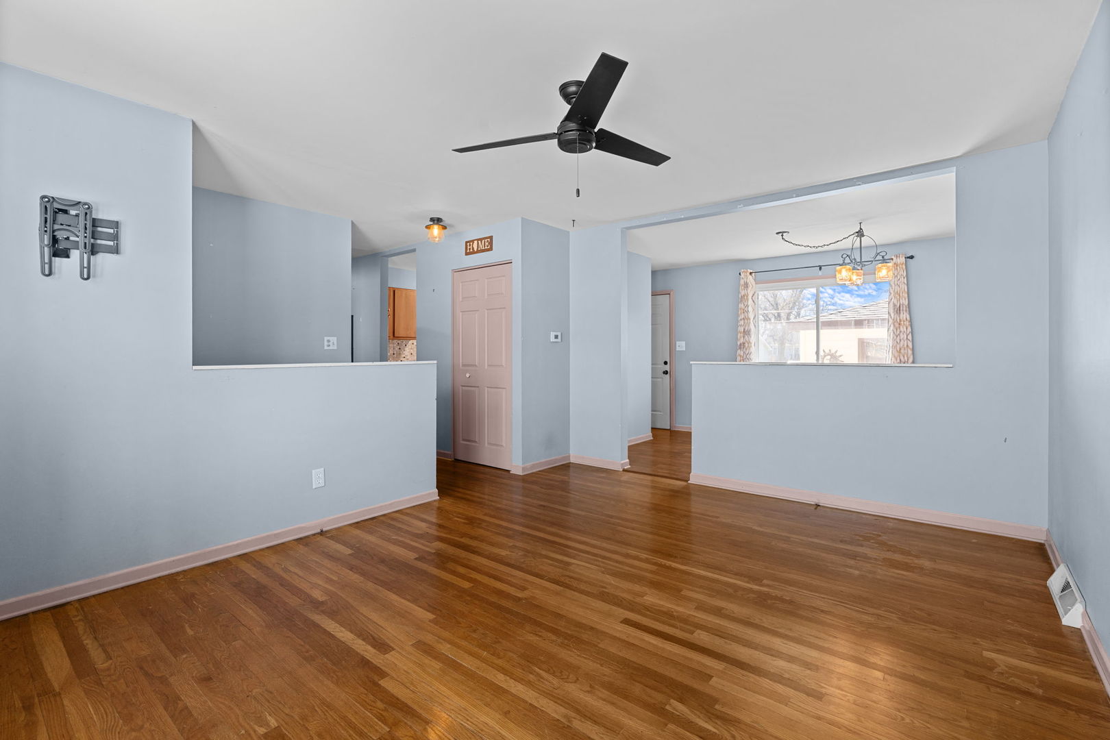 8911 Ramble Road Wonder Lake, IL 60097 - Photo 5 of 36 a view of empty room with wooden floor and ceiling fan