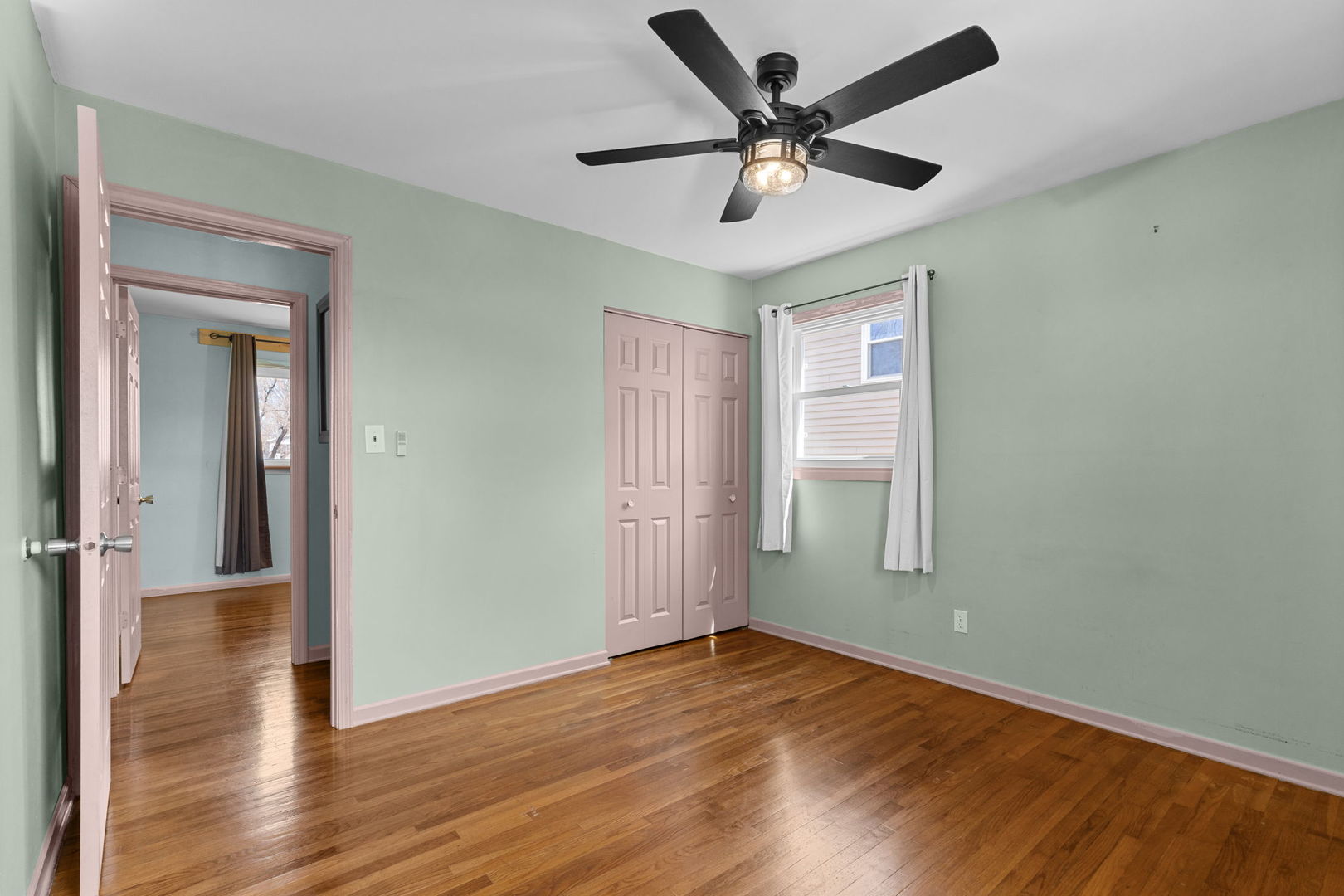 8911 Ramble Road Wonder Lake, IL 60097 - Photo 9 of 36 a view of a livingroom with a ceiling fan and wooden floor