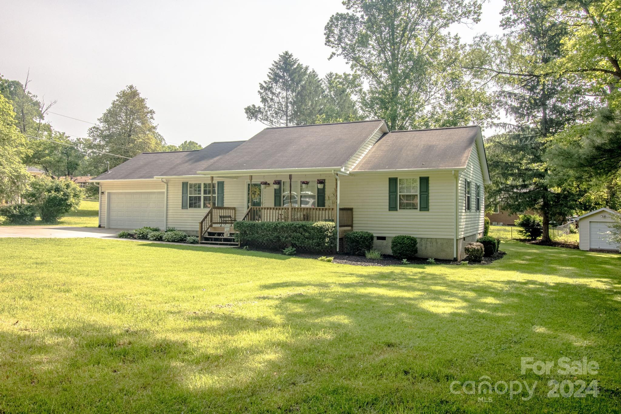 a front view of a house with a garden