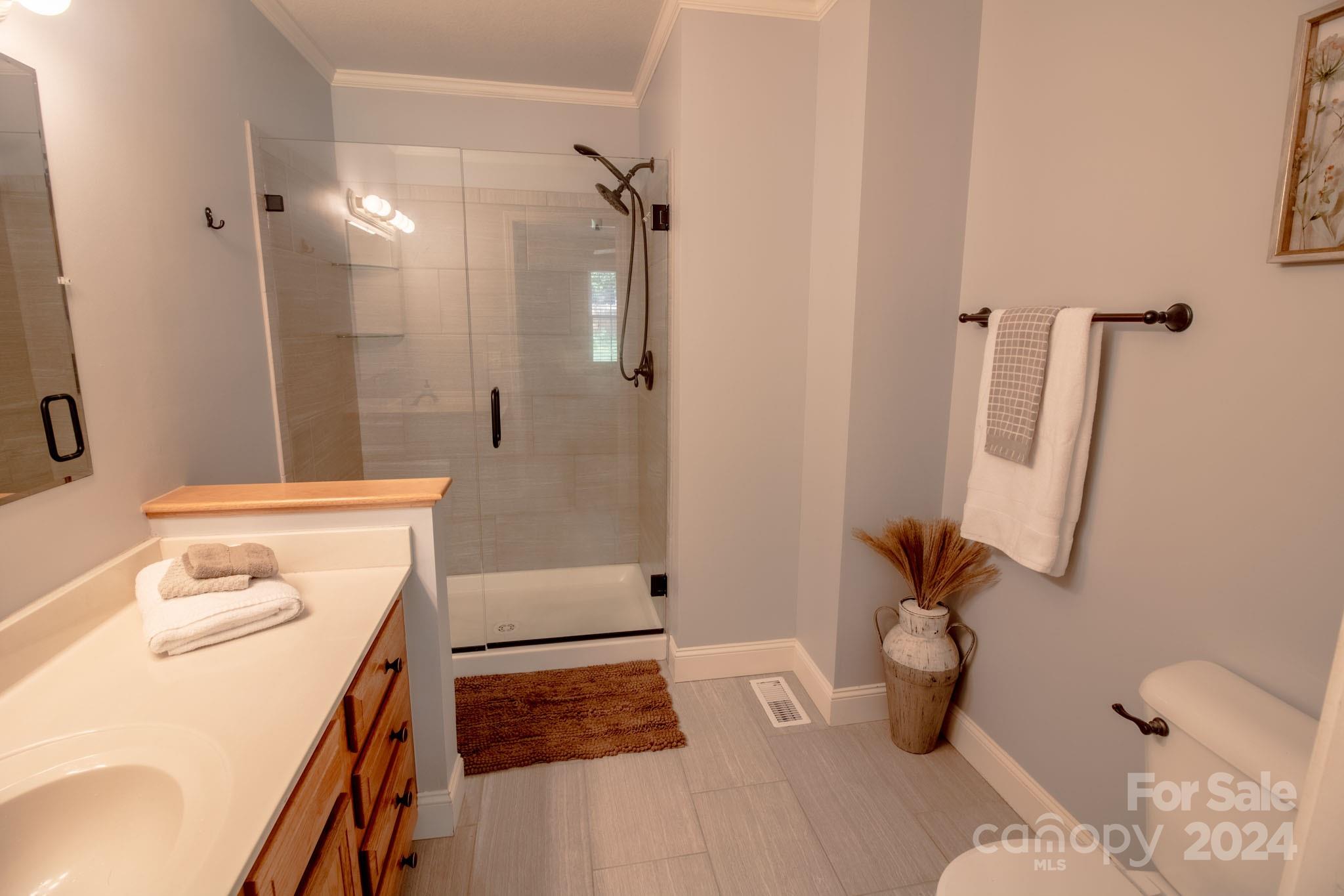 21 Norman Road Fletcher, NC 28732 - Photo 12 of 21 a bathroom with a sink toilet and shower