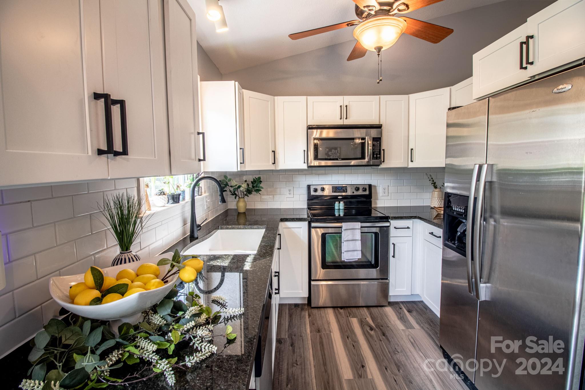 21 Norman Road Fletcher, NC 28732 - Photo 5 of 21 a kitchen with stainless steel appliances a stove a sink and a refrigerator