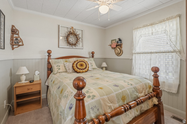 82 South 100 West Lyman, UT 84749 - Photo 22 of 27 Bedroom featuring crown molding, a wainscoted wall, a ceiling fan, and carpet floors