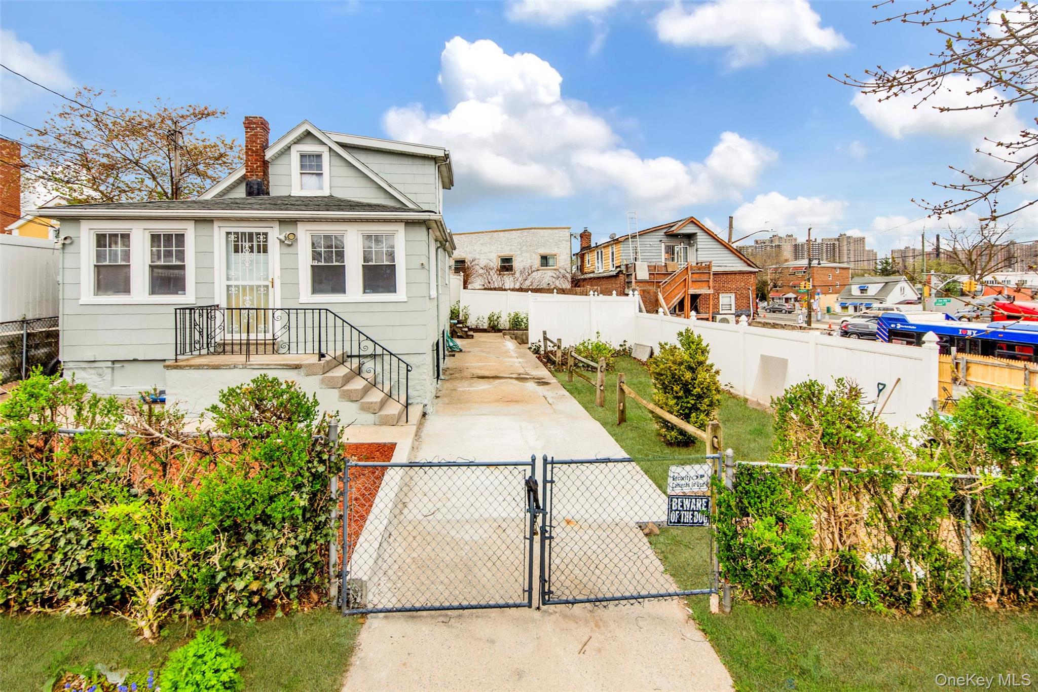 a view of a white house with a yard