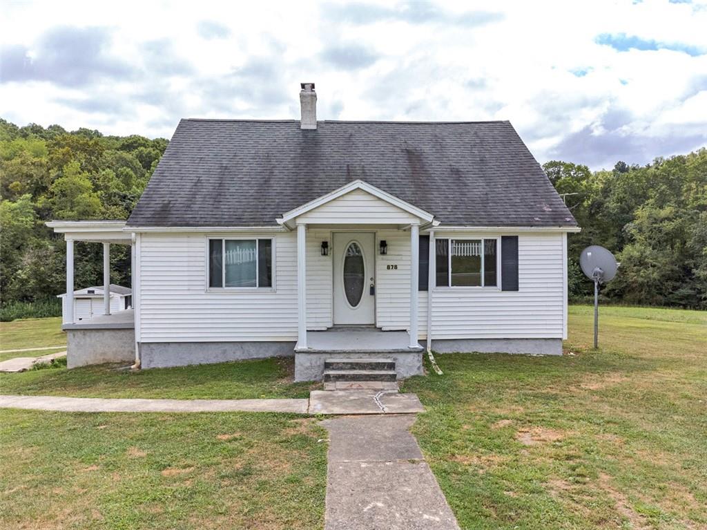 a front view of house with garden