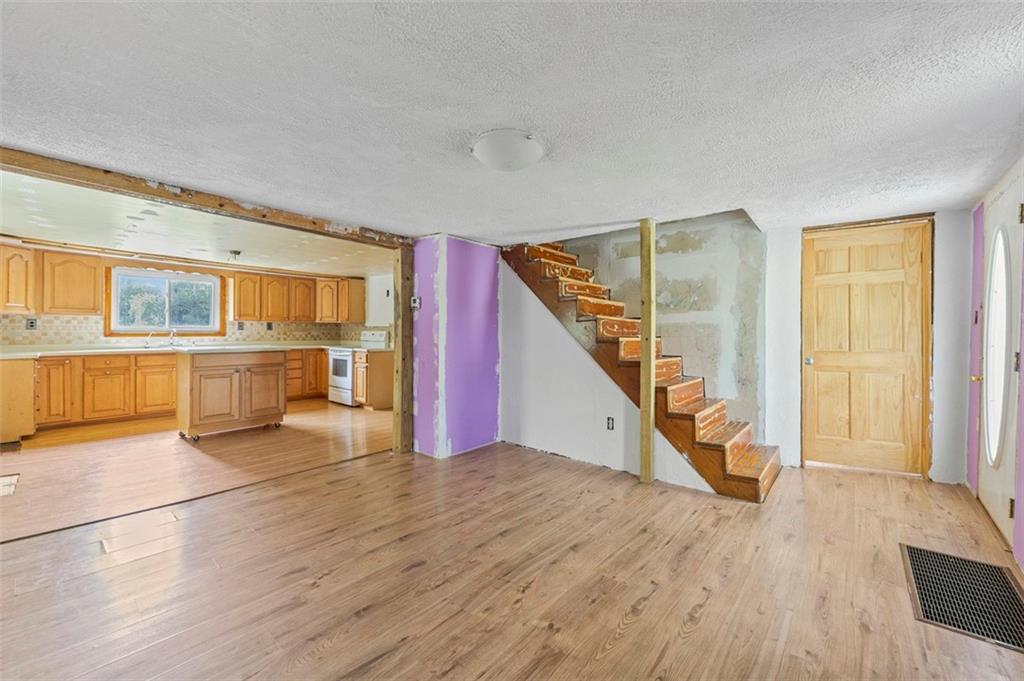 878 Bolden Road Smock, PA 15480 - Photo 11 of 23 an empty room with wooden floor and windows