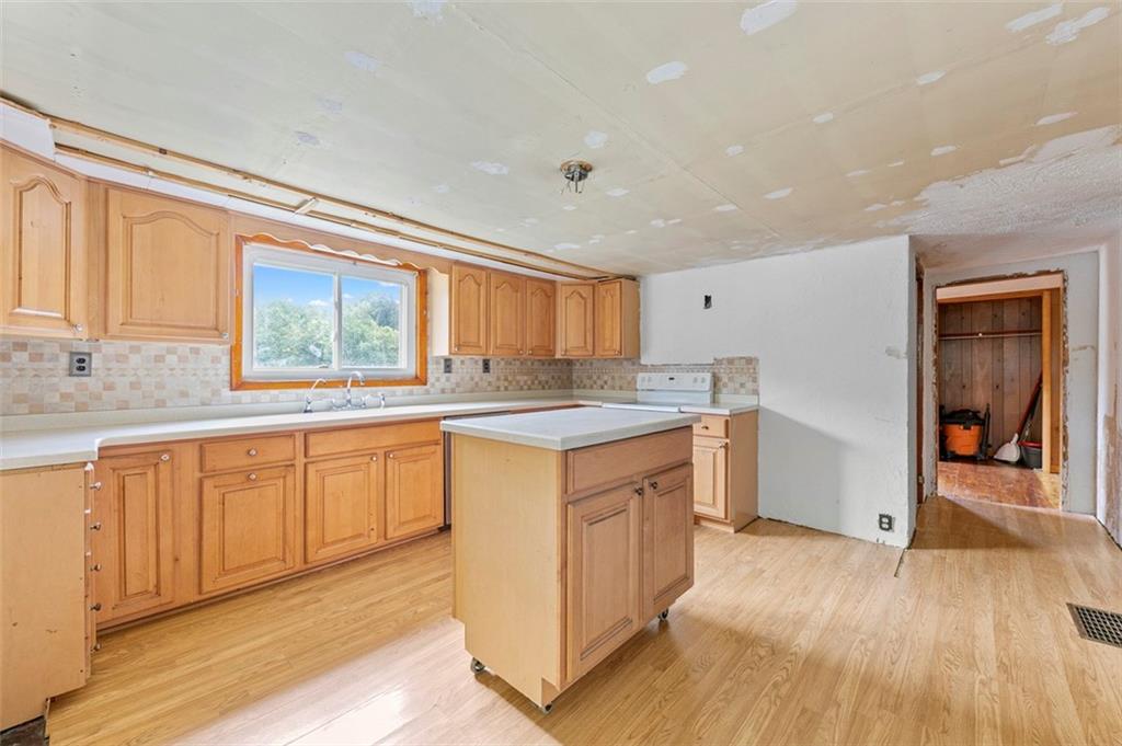 878 Bolden Road Smock, PA 15480 - Photo 13 of 23 a kitchen with stainless steel appliances granite countertop a stove a sink and a refrigerator