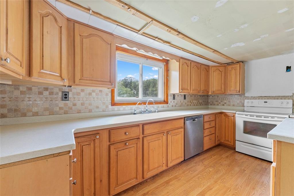 878 Bolden Road Smock, PA 15480 - Photo 15 of 23 a kitchen with granite countertop white cabinets and white appliances