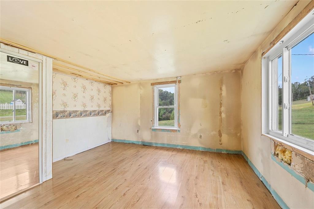 878 Bolden Road Smock, PA 15480 - Photo 16 of 23 an empty room with wooden floor and windows