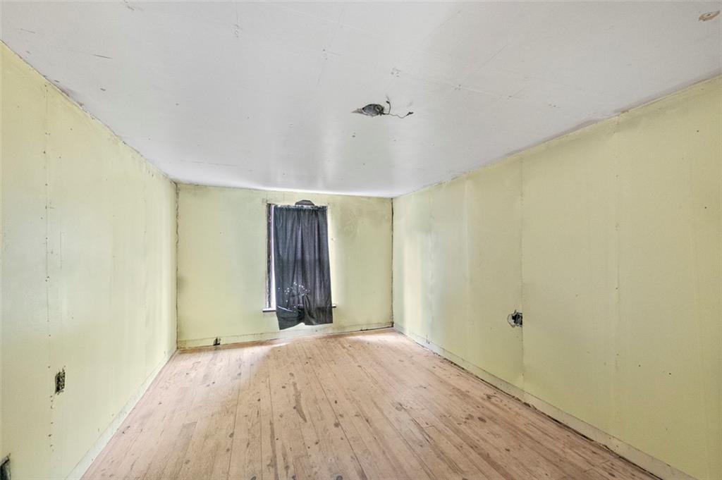 878 Bolden Road Smock, PA 15480 - Photo 19 of 23 a view of a big room with wooden floor and windows