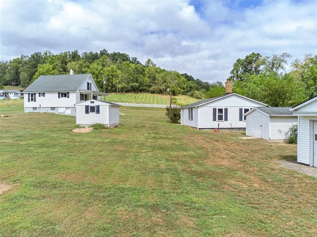 878 Bolden Road Smock, PA 15480 - Photo 3 of 23 a house view with swimming pool and trees in the background