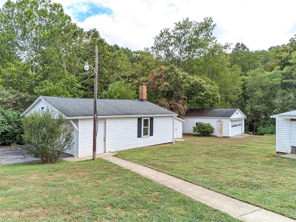 878 Bolden Road Smock, PA 15480 - Photo 6 of 23 a white house that has a tree in front of it
