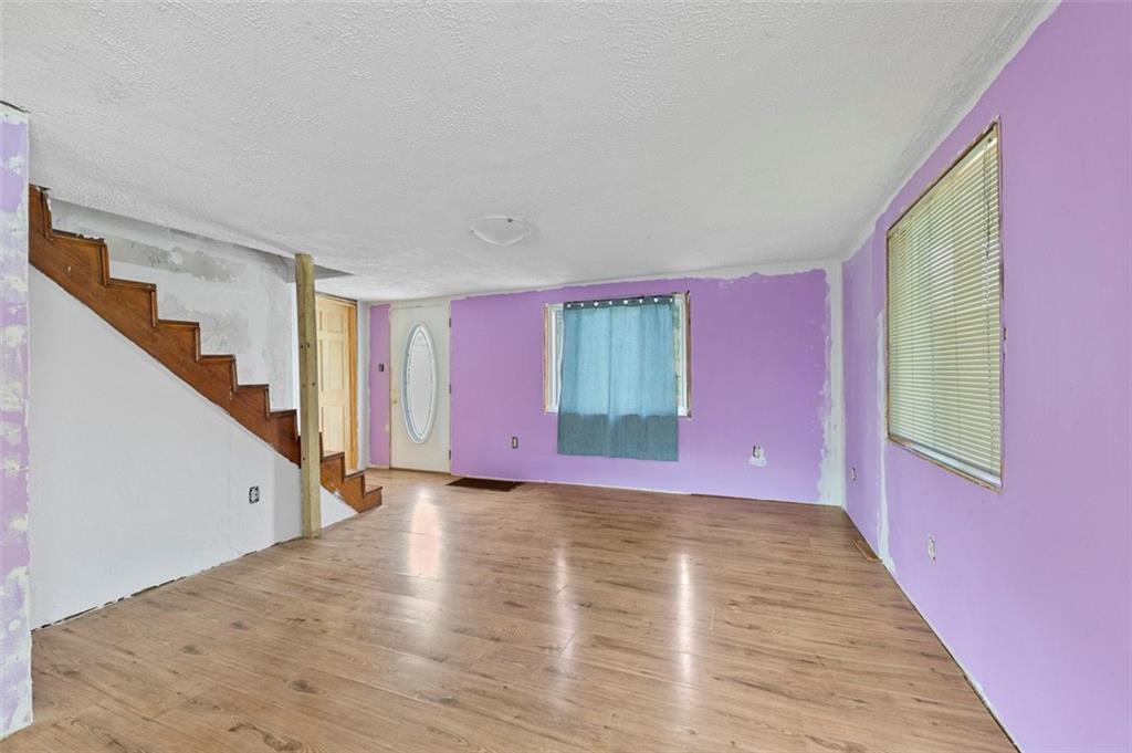 878 Bolden Road Smock, PA 15480 - Photo 10 of 23 a view of an empty room with wooden floor and a window