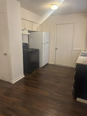 a view of a kitchen with wooden floor
