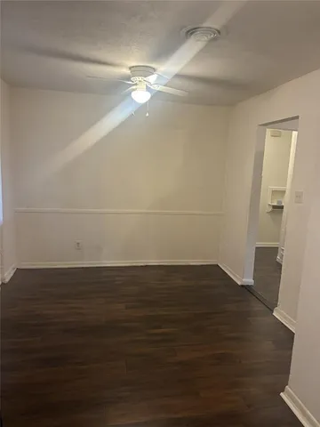 a view of a room with wooden floor