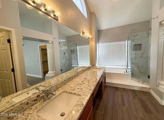 a spacious bathroom with a granite countertop tub sink and shower