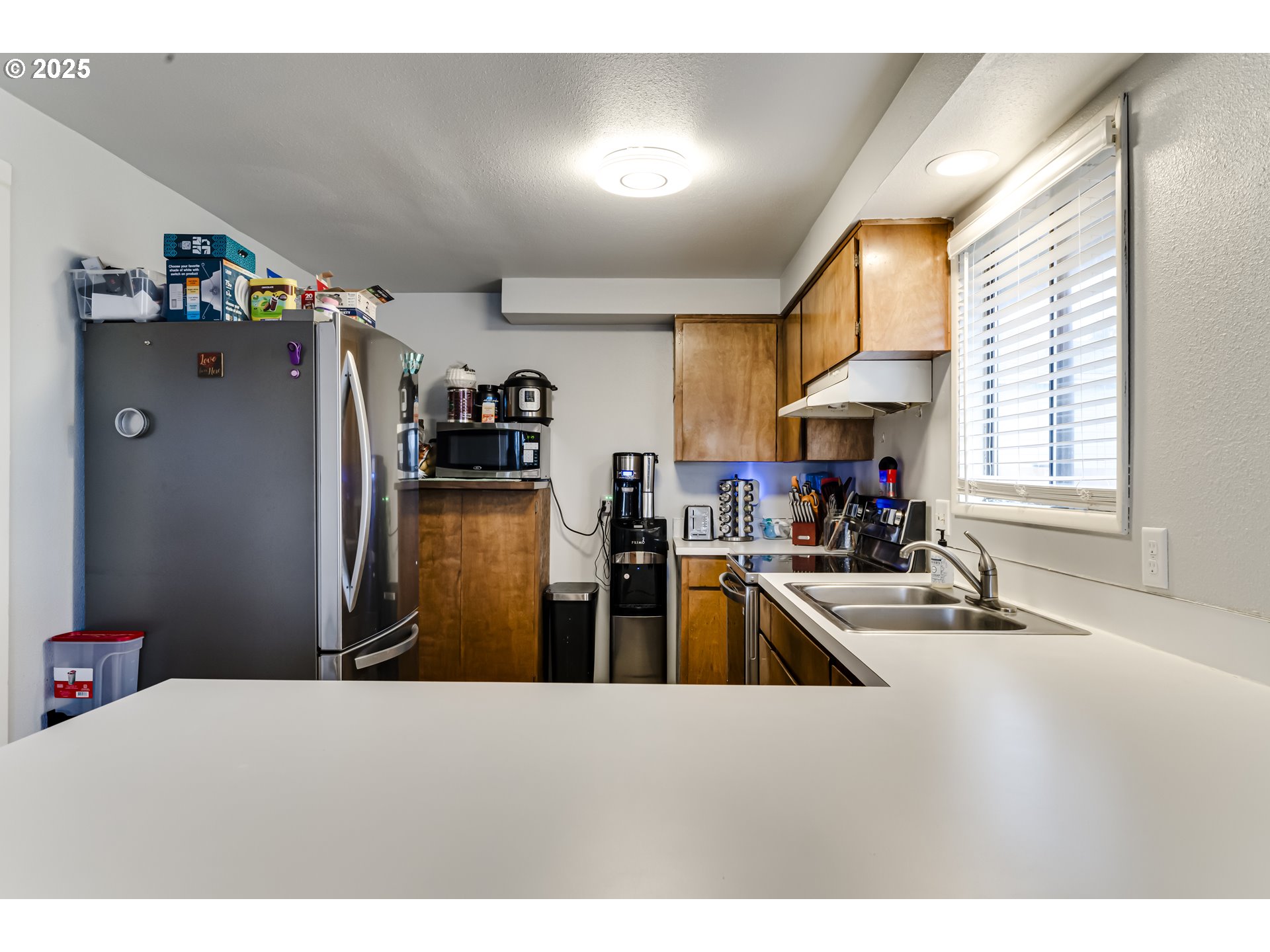 6865 Main Street Springfield, OR 97478 - Photo 11 of 48 a kitchen with stainless steel appliances granite countertop lots of counter top space and wooden floor