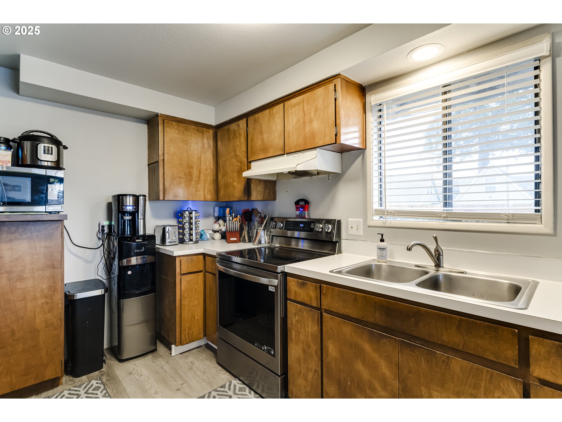 6865 Main Street Springfield, OR 97478 - Photo 12 of 48 a kitchen with a sink stove top oven and cabinets