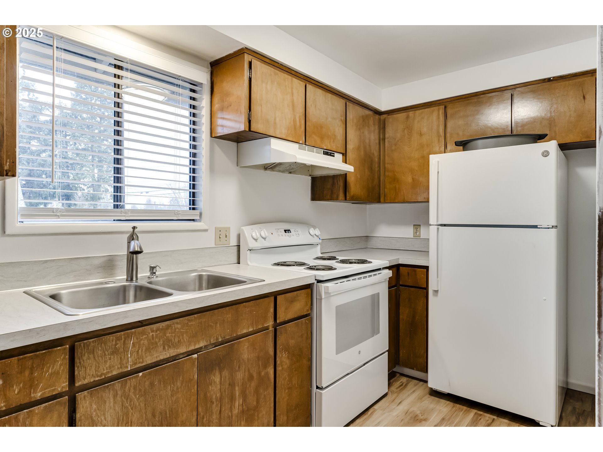 6865 Main Street Springfield, OR 97478 - Photo 34 of 48 a kitchen with a sink a refrigerator and cabinets