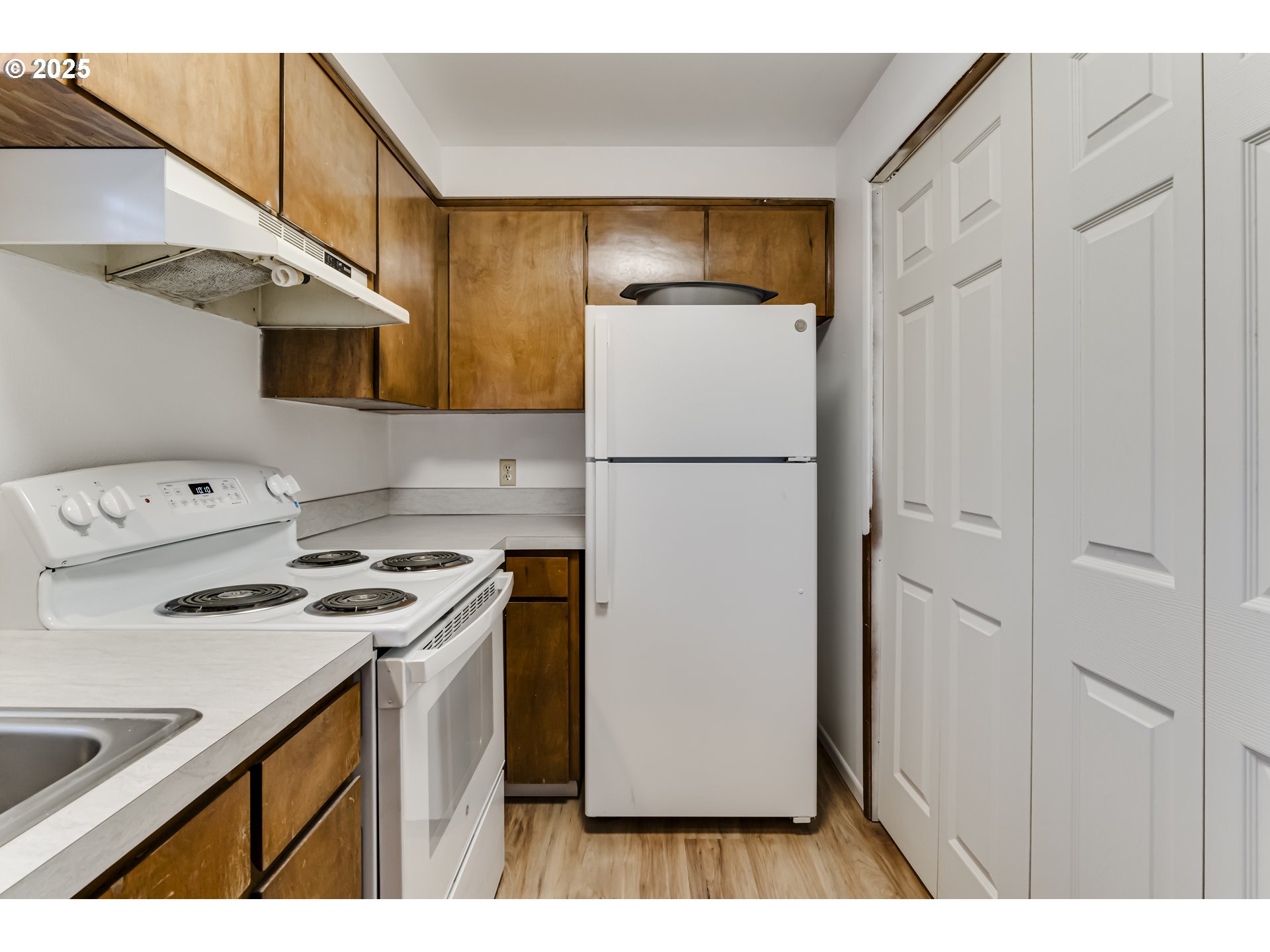 6865 Main Street Springfield, OR 97478 - Photo 36 of 48 a kitchen with a refrigerator a stove top oven a sink and cabinets