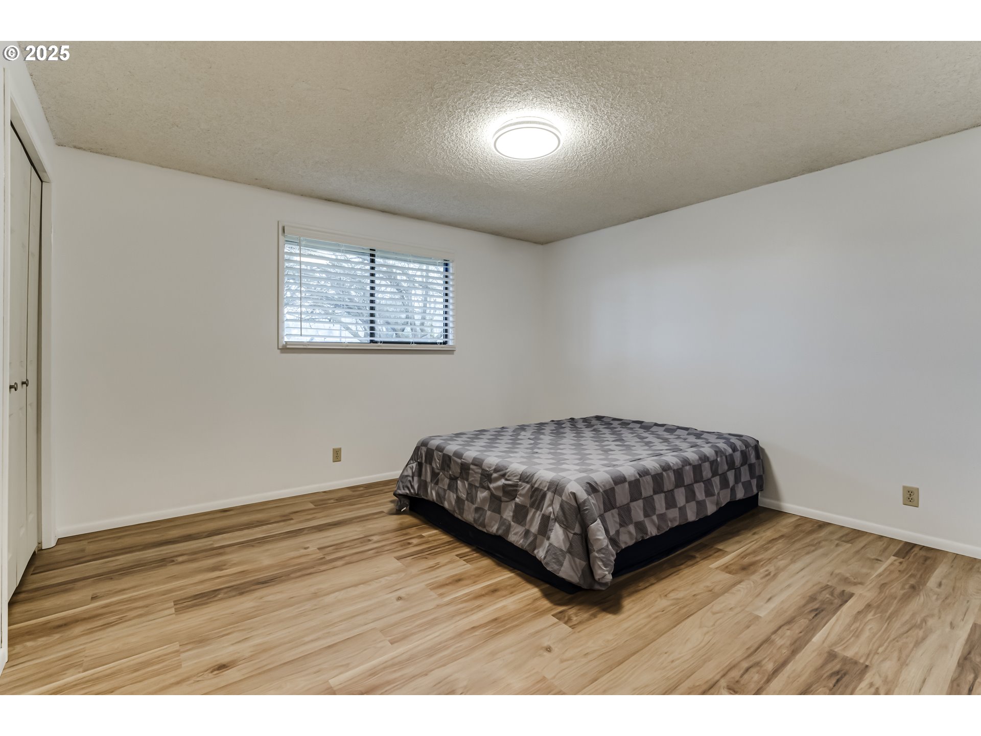 6865 Main Street Springfield, OR 97478 - Photo 42 of 48 a bedroom with a bed and wooden floor