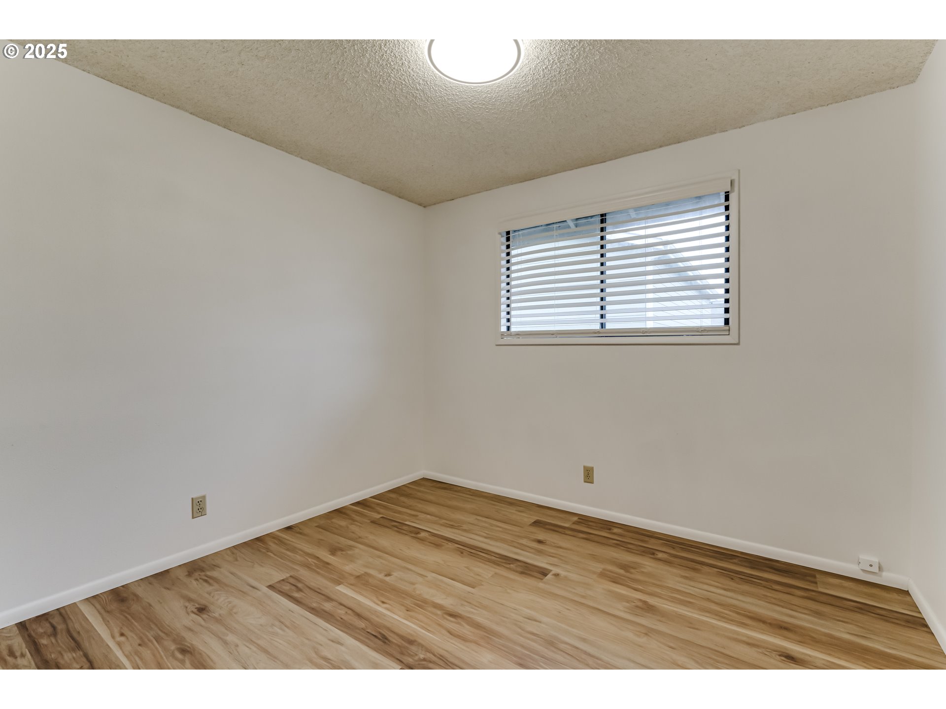 6865 Main Street Springfield, OR 97478 - Photo 45 of 48 a view of an empty room with wooden floor and a window
