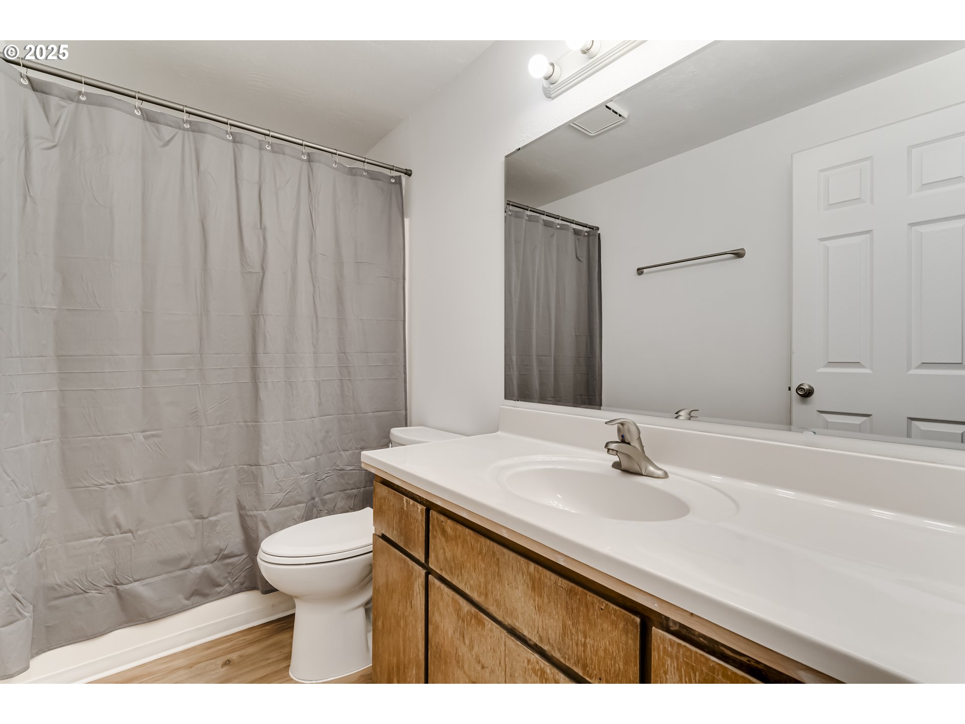 6865 Main Street Springfield, OR 97478 - Photo 46 of 48 a bathroom with a sink a toilet a mirror and shower curtain