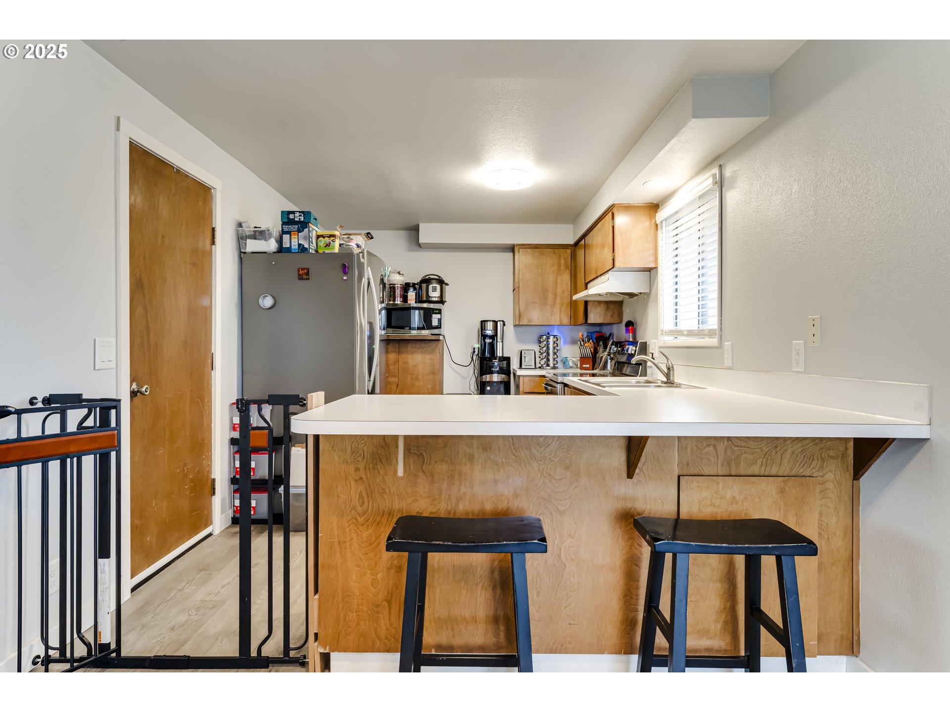 6865 Main Street Springfield, OR 97478 - Photo 10 of 48 a kitchen with a table chairs refrigerator and cabinets