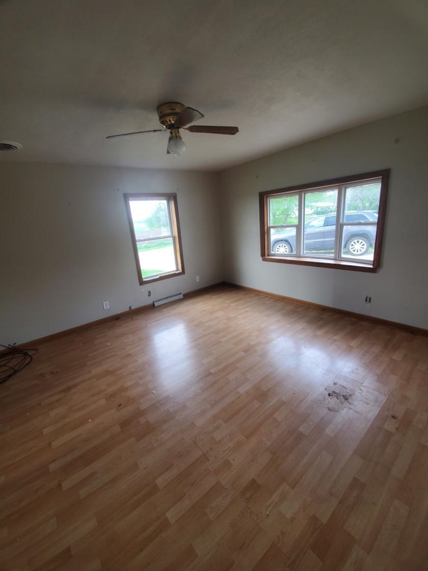 12463 West Haldane Road Forreston, IL 61030 - Photo 8 of 13 an empty room with wooden floor chandelier and windows