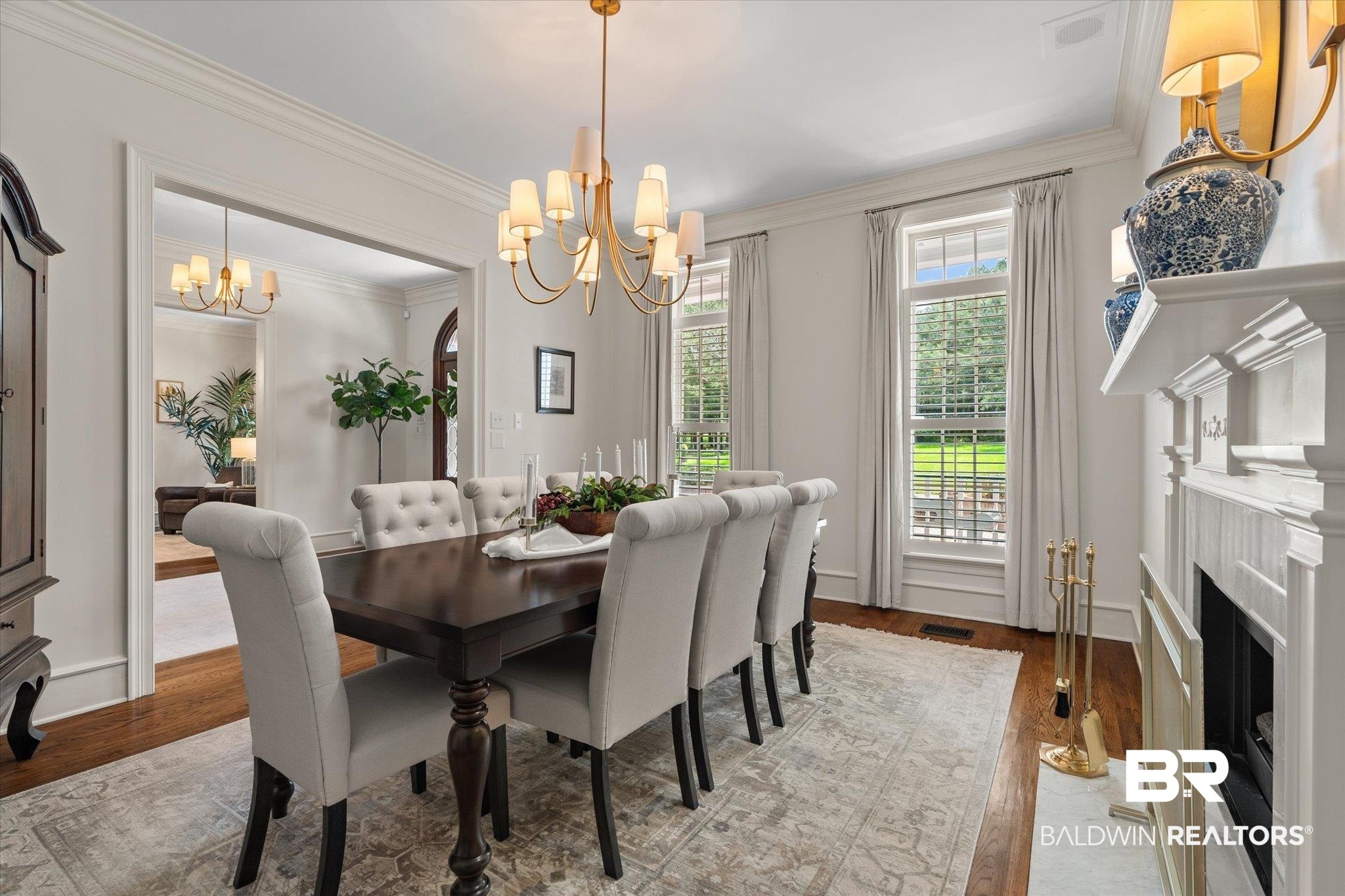 8561 Dawes Lake Road Mobile, AL 36619 - Photo 6 of 63 Dining area featuring a chandelier, wood finished floors, ornamental molding, and a fireplace