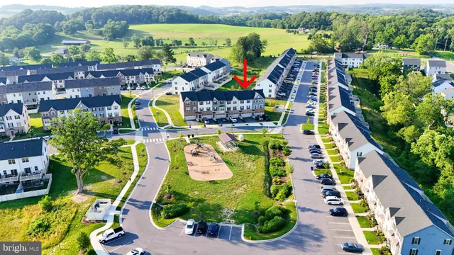 an aerial view of swimming pool patio and mountain view in back