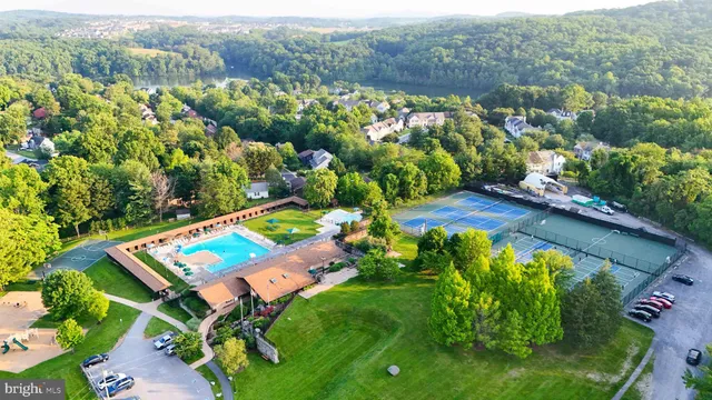 an aerial view of a house with a garden and lake view