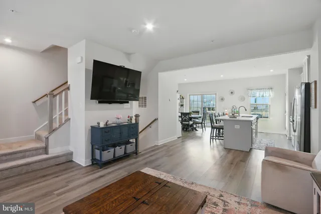 a living room with furniture wooden floor and a flat screen tv